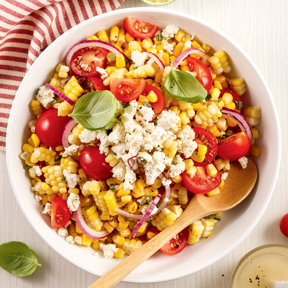 Salade de maïs, tomates cerises et feta avec basilic frais.